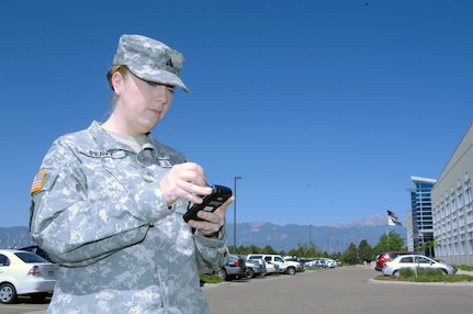 Army National Guard Sgt. Stephanie Peavy, 244th Army Liaison Team from Chicago, works with a "Life Ring" cell phone being demonstrated at the Coalition Warrior Interoperability Demonstration in Colorado Springs June 15. CWID is part exercise, part vendor demonstration, where companies offering new technologies can demonstrate their products in a realistic environment. The Life Ring is a cell phone system that combines a GPS and satellite communications, allowing continuous communication and tracking through a G3 network cell phone regardless of conditions on the ground. This allows first responders in a disaster situation to maintain contact with their organization leadership even if cell towers in the area have been destroyed.
