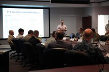 : Military and civilian Defense Support of Civil Authorities, or DSCA, planners discuss the schedule and topics for the two-day DSCA meeting held aboard Camp Lejeune, N.C., July 18, 2013. After a day of speaking about the responsibilities of each unit and organizations for humanitarian operations, the group played through the events of a hypothetical hurricane, which damaged Alabama and surrounding states, as a means to increase efficiency in an actual event.