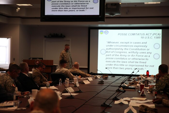 Military and civilian Defense Support of Civil Authorities, or DSCA, planners discuss the legal restrictions placed on service members taking part in humanitarian operations within the United States during a DSCA meeting held aboard Camp Lejeune, N.C., July 18, 2013. The meeting covered the plans of action for multiple organizations involved in relief efforts and how the organizations would work together.