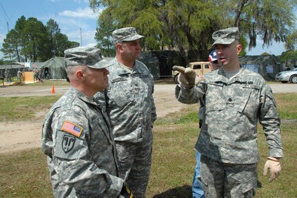 From right to left, Lt. Col. Eric Maxon, a National Guard Bureau public affairs officer, Col. Peter J. Brooks, the South Carolina National Guard public affairs officer, and Master Sgt. Paul Mouilleseaux, also of the National Guard Bureau public affairs office, discuss placement of joint information center equipment on Tuesday, April 15, in Beaufort, S.C. Public affairs specialists from various states have been sent to South Carolina to support the exercise. Vigilant Guard is a three-day National Guard-hosted exercise in Beaufort, beginning April 21. The exercise is designed to better prepare the National Guard for natural disasters in a cooperative effort with various national, state and local government agencies. It is the nation's largest ever National Guard (NGB) sponsored exercise.