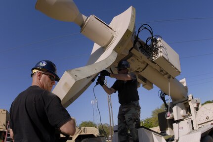 Master Sgts. Troy Wilkerson (left) and Ed McManus from Eagle Vision install a "petal" on their commercial satellite antenna on 17 April 2008. They are supporting emergency exercise senarios for the Vigilant Guard Exercise in Beaufort, South Carolina. Eagle Vision is assigned to the South Carolina Air National Guard's 169th Communications Flight from McEntire Joint National Guard Base in Eastover, SC. Their role as a commerical satellite antenna mobile ground station is to provide communications, imagery, and data to users from civil engineers and intelligence units. During a time of disaster, Eagle Vision provides satellite imagery to military, federal, and civil authorities.