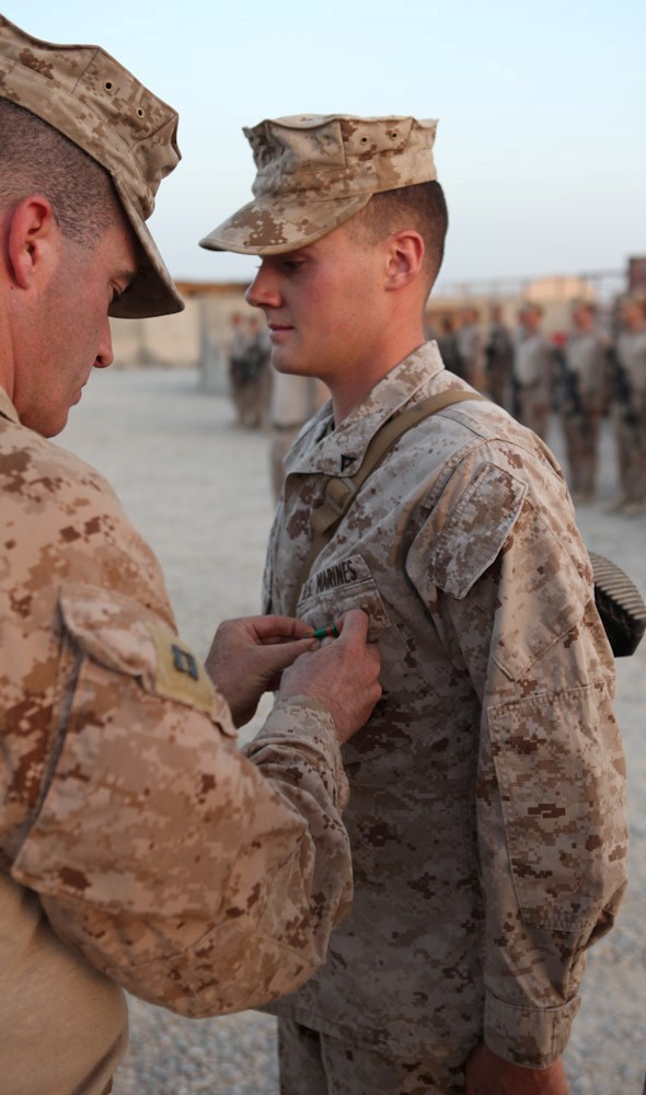 Lance Cpl. Jesse Pearsall, 20, from Gloucester, Va., is awarded the Navy and Marine Corps Achievement Medal by Capt. Todd Richardson, the Echo Company commander with 2nd Battalion, 8th Marine Regiment, Regimental Combat Team 7, for his decisive thinking and quick response to a car accident. "They didn't have to stop," said Joseph Burger, a platoon commander with 2nd Bn., 8th Marines. "They could've been like every person who drove by, but they didn't, and that's what sets them apart from others."