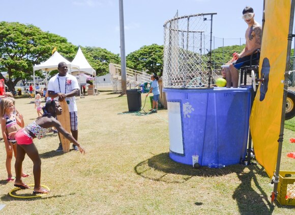 Makenzie Goode, 7, attempts to hit a target at the dunk tank during the Summer Splashdown at Riseley Field, July 13, 2013. (U.S. Marine Corps photo by Kristen Wong)