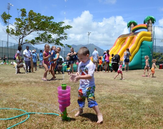 Ethan Bowles, 4, plays with a water toy during the Summer Splashdown at Riseley Field, July 13, 2013. (U.S. Marine Corps photo by Kristen Wong)