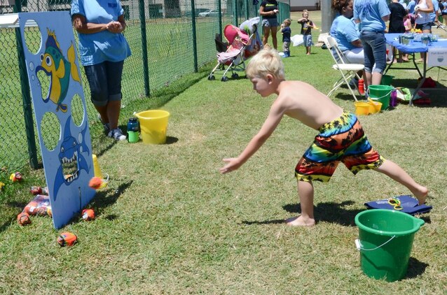 Cayden Toledo, 7, tries his luck in a ball-tossing game during the Summer Splashdown at Riseley Field, July 13, 2013. Marine Corps Base Hawaii families engaged in numerous water activities at the event. (U.S. Marine Corps photo by Kristen Wong)