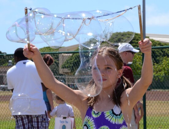 Madison Frazier, 11, plays with a bubble-maker during the Summer Splashdown at Riseley Field, July 13, 2013. Marine Corps Base Hawaii families engaged in numerous water activities at the event. (U.S. Marine Corps photo by Kristen Wong)