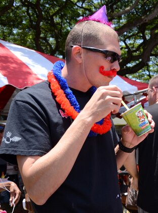 Lt. John Paul, an ordnance officer with Marine Aviation Logistics Squadron 24 eats a cool treat during the Marine Aircraft Group 24 chili cook-off at Dewey Square, July 3, 2013. Paul also competed in the cook-off with the “Explosion” team. (U.S. Marine Corps photo by Kristen Wong)