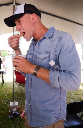 Lance Cpl. Nathan Rose, a fueler with Marine Wing Support Detachment 24 eats a cracker with his chili during the Marine Aircraft Group 24 chili cook-off at Dewey Square, July 3, 2013. (U.S. Marine Corps photo by Kristen Wong)