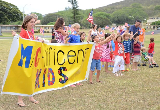 The children of Marine Aircraft Group 24 finish marching in a mini-parade before the MAG-24 chili cook-off at Dewey Square, July 3, 2013. (U.S. Marine Corps photo by Kristen Wong)