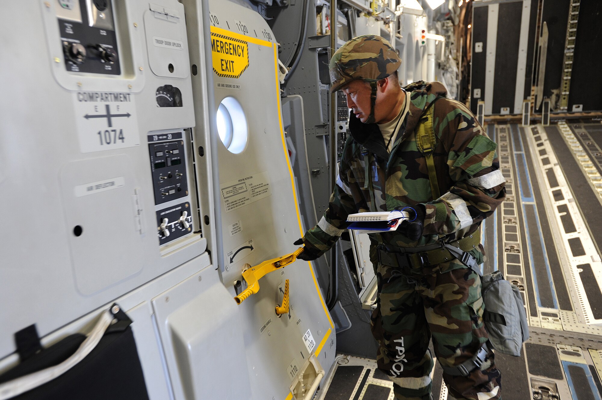 Master Sgt. Garrick Hiramoto, Hawaii Air National Guard 204th Airlift Squadron loadmaster, performs pre-flight inspections aboard a C-17 Globemaster III during an Operational Readiness Exercise at Joint Base Pearl Harbor-Hickam, Hawaii, July 18, 2013.  (U.S. Air Force photo/Tech. Sgt. Jerome S. Tayborn)  