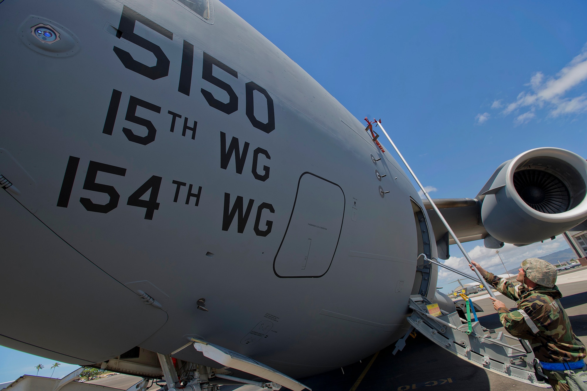 Master Sgt. Eric Hunt, 15th Aircraft Maintenance Squadron production superintendent, removes the pitot tube covers from a C-17 Globemaster III during an Operational Readiness Exercise at Joint Base Pearl Harbor-Hickam, Hawaii, July 18, 2013. The C-17 can carry up to 170,900 pounds of cargo, and can be configured for a variety of loadouts, including aeromedical evacuation, cargo transportation and passenger movement. (U.S. Air Force photo/Tech. Sgt. Jerome S. Tayborn)