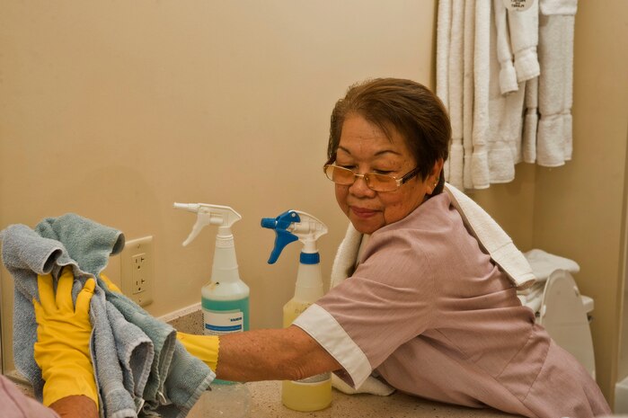 Elnora Canencia, 99th Force Support Squadron housekeeper, wipes down a mirror during a routine cleaning in preparation for the next guest at the Nellis Inn July 18, 2013, at Nellis Air Force Base, Nev. Each housekeeper is responsible for cleaning and preparing up to 20 rooms each day with a deadline of 20 minutes for each room. (U.S. Air Force photo by Senior Airman Daniel Hughes)