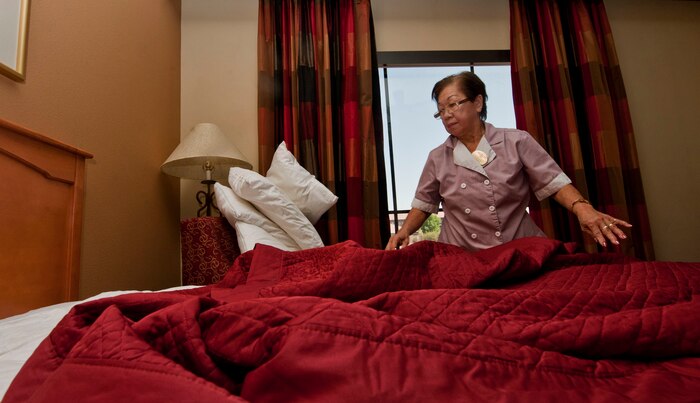 Elnora Canencia, 99th Force Support Squadron housekeeper, makes a bed during a routine cleaning at the Nellis Inn July 18, 2013, at Nellis Air Force Base, Nev. The housekeepers have a checklist with more than 100 items that need to be ready and inspected within 20 minutes for each room. (U.S. Air Force photo by Senior Airman Daniel Hughes)