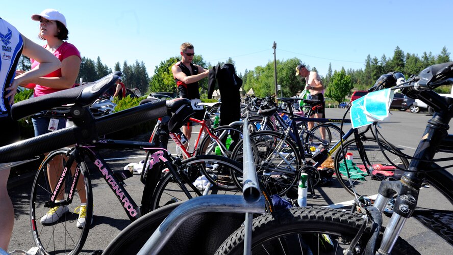 Triathlon participants prepare their bicycles for the 15 mile biking portion of the Clear Lake triathlon near Medical Lake, Wash., July 20. 2013.  The triathlon is held every year at the Clear Lake Resort south of Medical Lake. (U.S. Air Force photo by Airman 1st Class Ryan Zeski/Released)