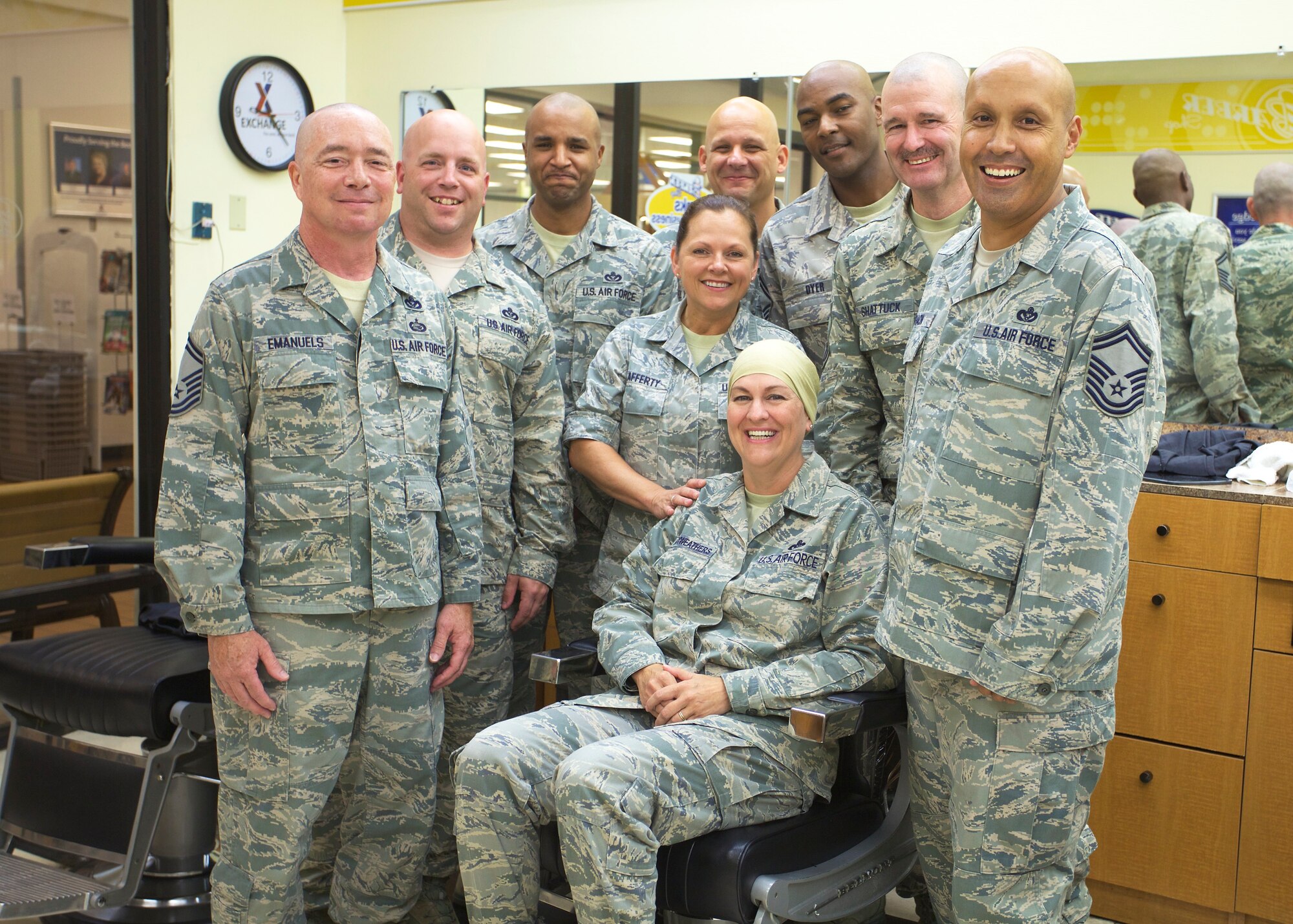 TYNDALL AIR FORCE BASE, Fla. -- AFTER: Members of the Air Force Civil Engineer Center’s Force Development Division demonstrated the Wingman concept in a big way and posed for a photo after they all shaved their heads in support of a fellow Airman dealing with cancer. Pictured from left, Senior Master Sgt. Spencer Emanuels, Master Sgt. Eric Johnson, Master Sgt. Chris Beach, Master Sgt. Michelle Lafferty, Senior Master Sgt. Gary Szekely, Senior Master Sgt. Alvin Dyer, Chief Master Sgt. Trevor Shattuck and Senior Master Sgt. Rigoberto Chacon. Master Sgt. Marla Manyweathers is pictured in the center of her Wingmen. (U.S. Air Force photo/Eddie Green)