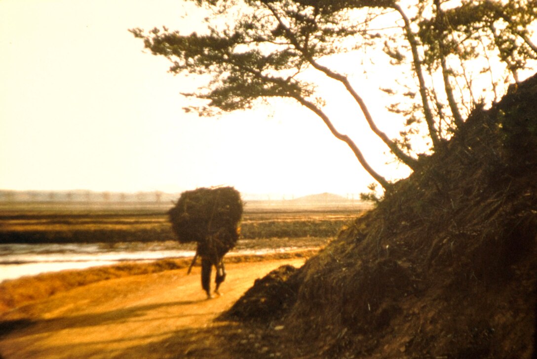 A South Korean man carries a load on his back near the 38th parallel. Retired U.S. Army Maj. E. Vernon Smith Jr. used photography as a way to preserve memories of his experience during his rotation there from 1956-58. (Courtesy photo/Released) 