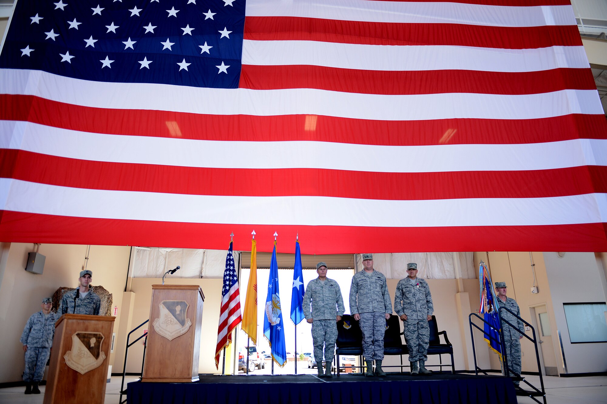 U.S. Air Force Lt. Gen. Eric Fiel, Air Force Special Operations Command commander, Col. Tony Bauernfeind, 27th Special Operations Wing commander, and Brig. Gen. Buck Elton, 27 SOW relinquishing commander, stand at attention during a change of command ceremony July 23, 2013, at Cannon Air Force Base, N.M.  Bauernfeind succeeded Elton, who led the wing since July 2011.  (U.S. Air Force photo/Staff Sgt. Matthew Plew)