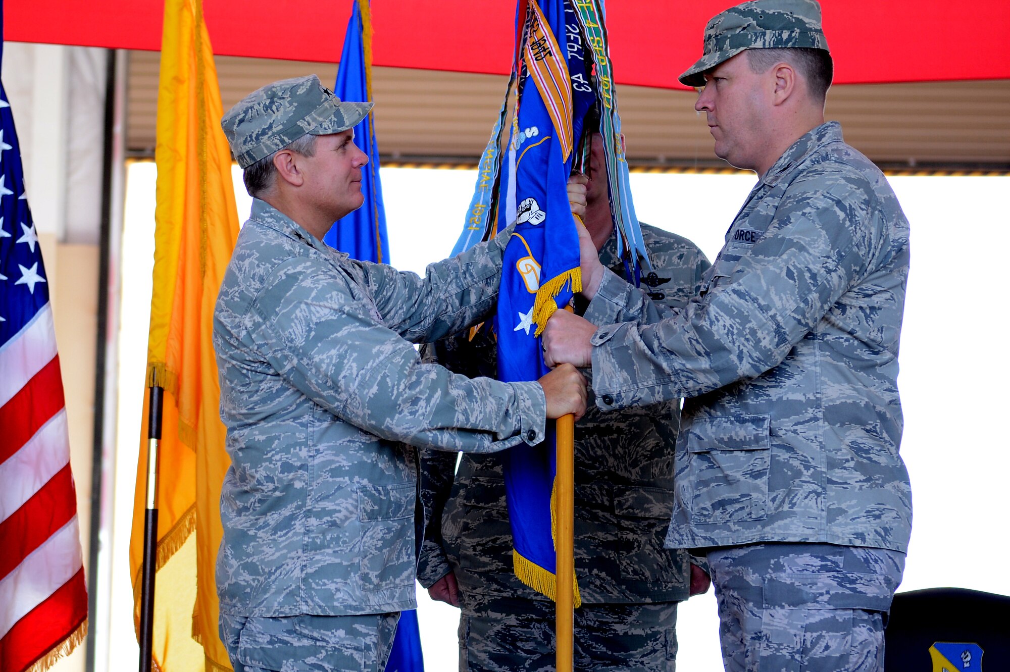U.S. Air Force Lt. Gen. Eric Fiel, Air Force Special Operations Command commander, passes the guidon to Col. Tony Bauernfeind, 27th Special Operations Wing commander, in a change of command ceremony July 23, 2013, at Cannon Air Force Base, N.M. Bauernfeind succeeded Brig. Gen. Buck Elton, who led the wing since July 2011.  (U.S. Air Force photo/Staff Sgt. Matthew Plew)