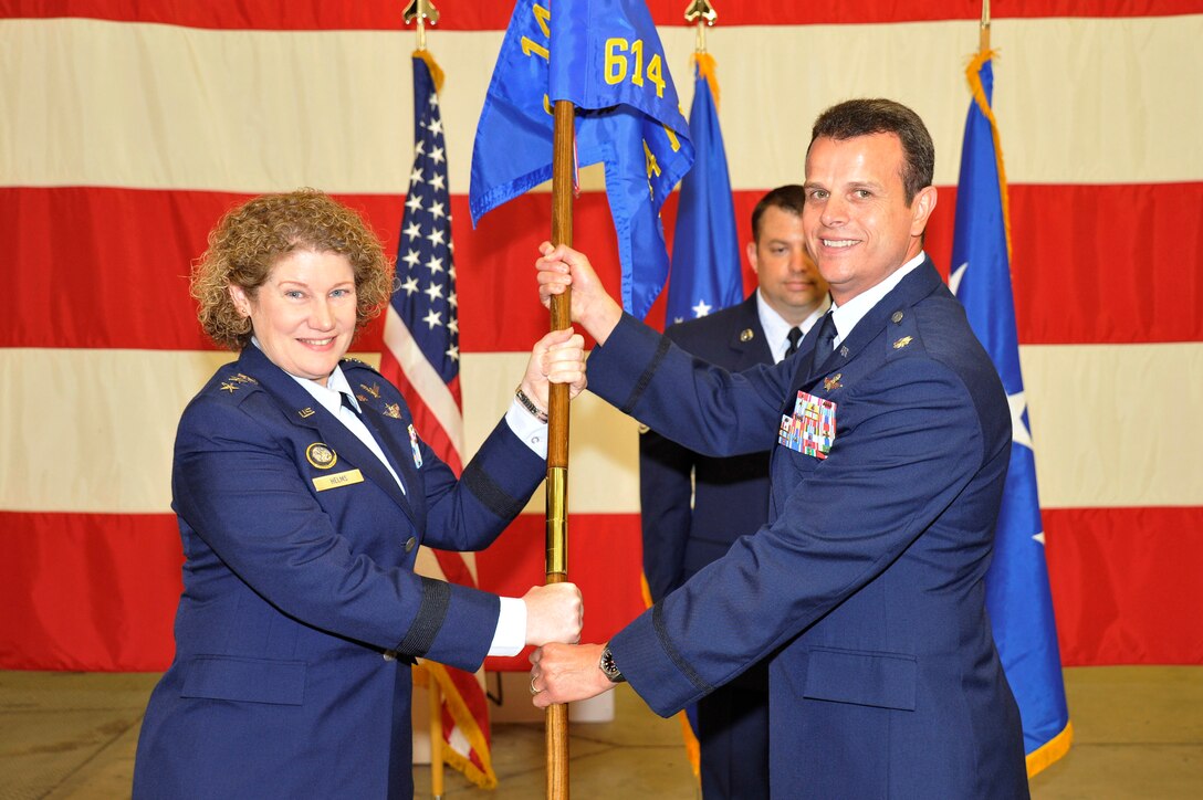 VANDENBERG AIR FORCE BASE, Calif. -- Lt. Gen. Susan Helms, commander of U.S. Strategic Command's Joint Functional Component Command for Space and 14th Air Force (Air Forces Strategic) presents the 614th Air and Space Communications Squadron guidon to Lt. Col. Timothy Ryan, the new 614th ACOMS commander, during a ceremony here July 9, 2013. (U.S. Air Force photo/Michael Peterson)