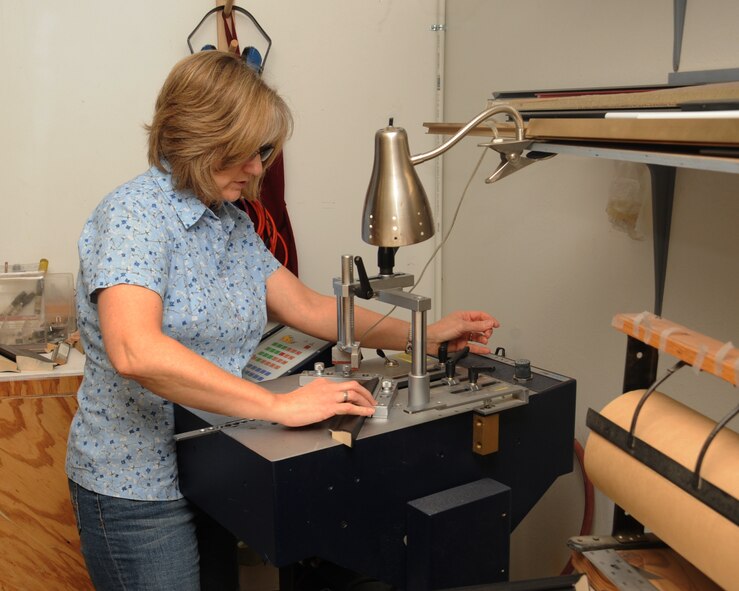 Brenda Porter, 2nd Force Support Squadron frame shop employee, assembles a frame on Barksdale Air Force Base, La., July 23, 2013. Porter has been working at the frame shop for more than 10 years. (U.S. Air Force photo/Senior Airman Sean Martin)