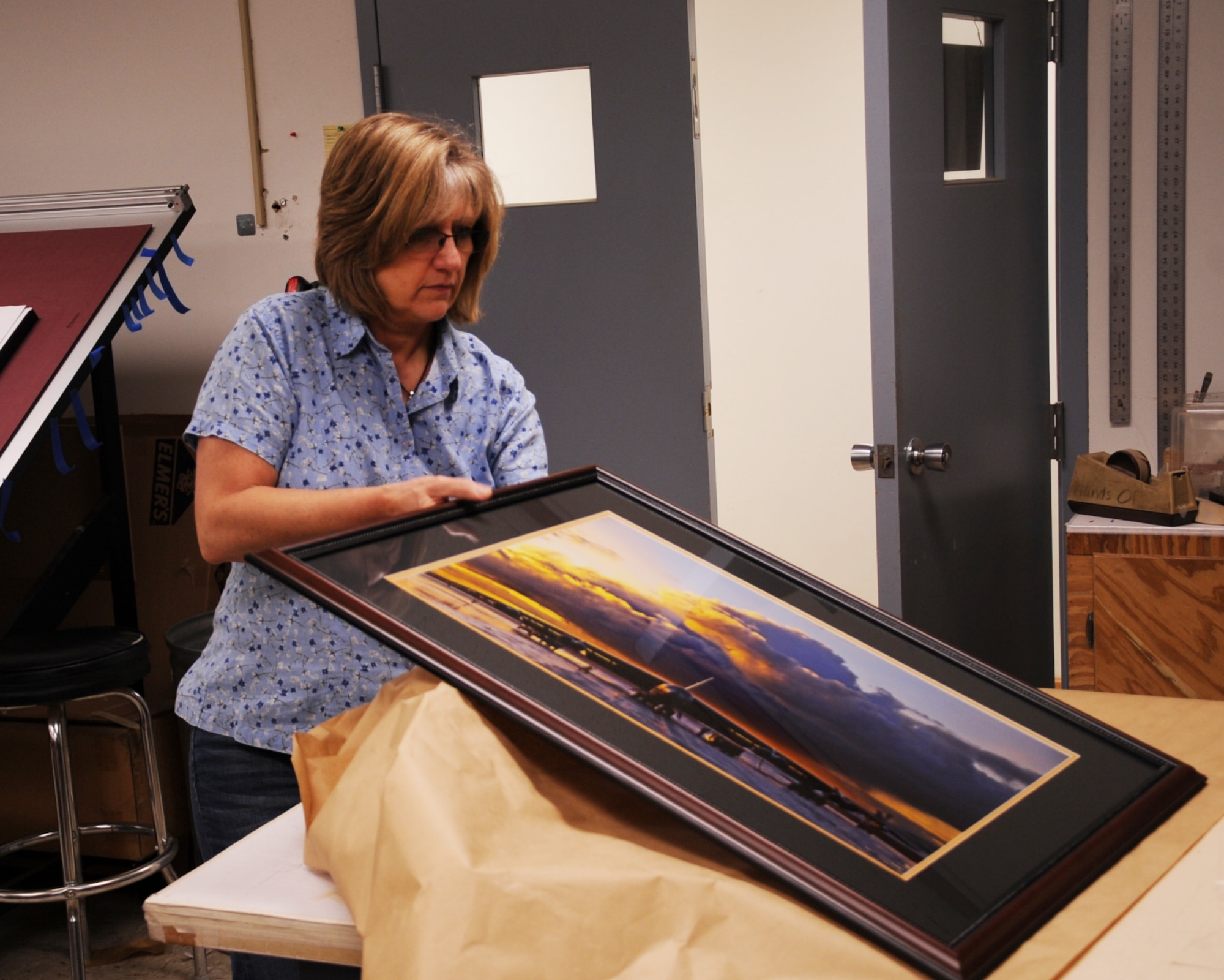 Brenda Porter, 2nd Force Support Squadron frame shop employee, wraps a photo for a customer on Barksdale Air Force Base, La., July 23, 2013. The frame shop is open Monday through Friday from 9 a.m. to 5 p.m. (U.S. Air Force photo/Senior Airman Sean Martin)