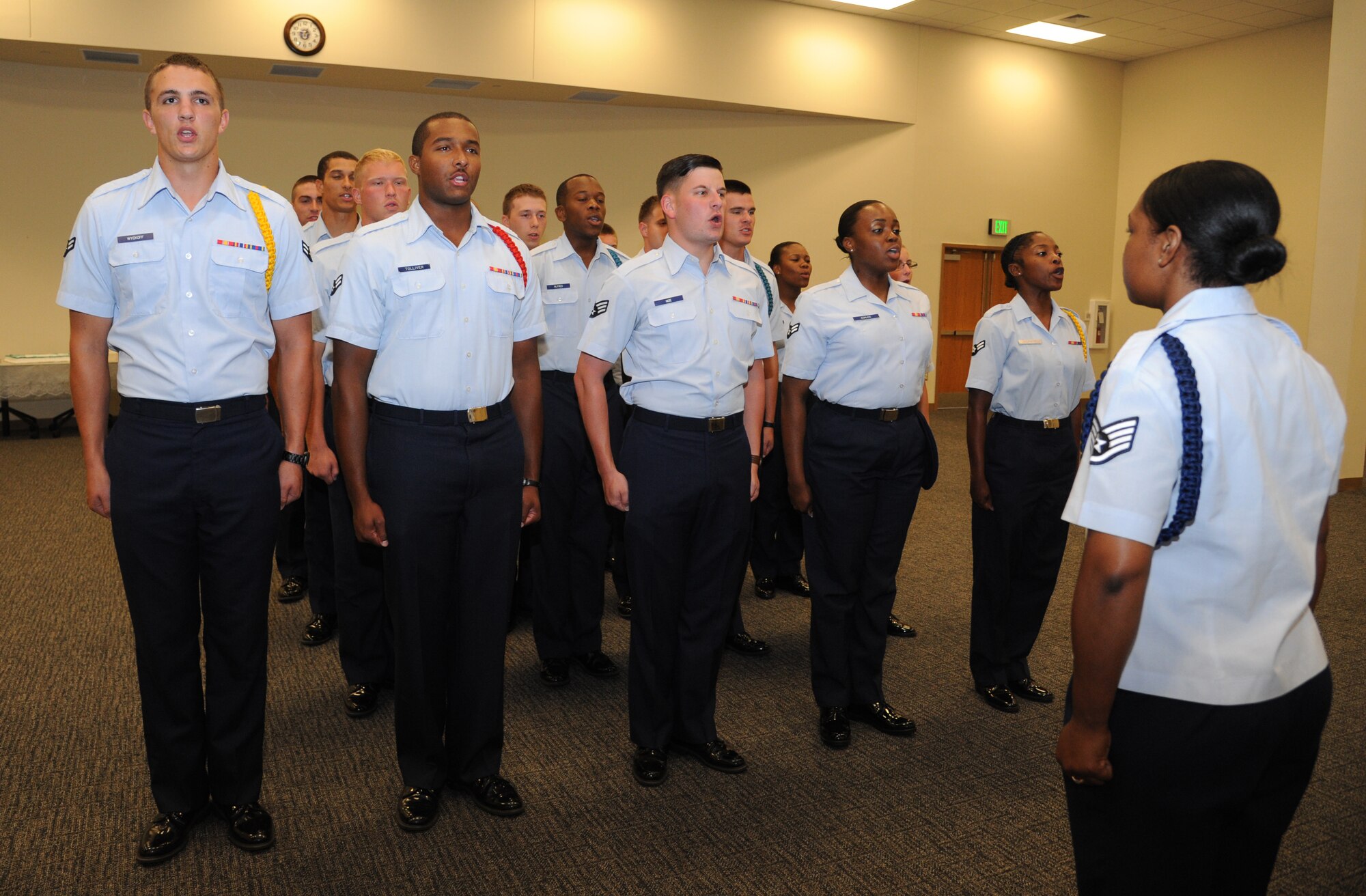 Airmen from the 335th Training Squadron deliver the bulls chant to welcome Lt. Col. Dorene Ross, incoming 335th Training Squadron commander, during the 335th TRS change of command ceremony July 22, 2013, at the Roberts Consolidated Aircraft Maintenance Facility, Keesler Air Force Base, Miss.  Col. George Tombe, 81st Training Group commander, was the officiating officer for the event and Lt. Col. Bradley McAlpine was the outgoing 335th TRS commander.  (U.S. Air Force photo by Kemberly Groue)