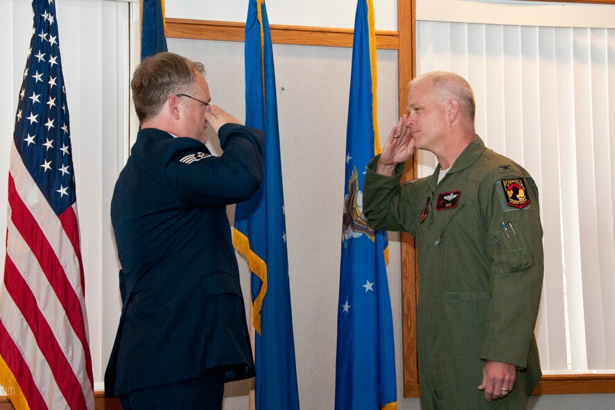 Staff Sgt. William Gray (left) presents one last salute to Col. William Dehaes, Commander, 132nd Fighter Wing (132FW), Des Moines, Iowa, during the last minutes of Staff Sgt. Gray's retirement ceremony from the 132FW on July 12, 2013. Staff Sgt. Gray contributed 23 years of his life to the military, serving  in three different branches.  (U.S. Air National Guard photo by Senior Airman Dustin M. Smart/Released)