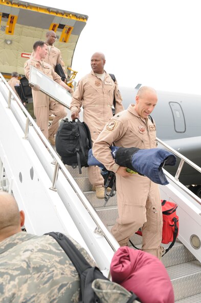Members from the 459th Operations Group bring their bags down from a KC-135 Stratotanker at Joint Base Andrews, Md., July 22, 2013. The members returned home from a deployment to Southwest Asia in support of Operation Enduring Freedom. (U.S. Air Force photo/ Capt. Tim Smith)