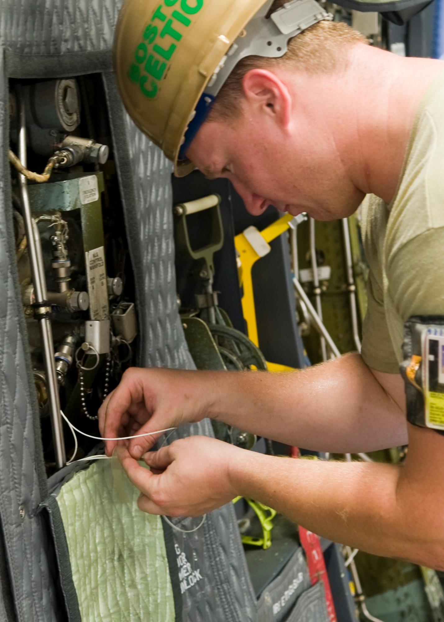 Staff Sgt. Ben Randall, 436th Maintenance Group electrical and environmental technician, repairs a broken front landing gear wire for the C-5M Super Galaxy July 19, 2013, at Dover Air Force Base, Del. Fixing the wire allowed the aero repair shop to finish checks on the landing gear. (U.S. Air Force photo/Senior Airman Jared Duhon) 