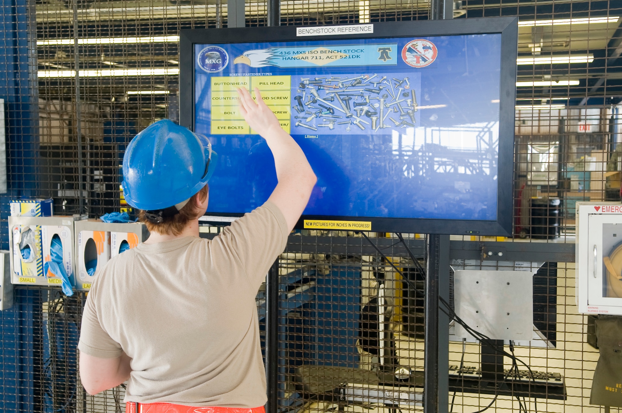 Airman 1st Class Mary Boykein, 436th Maintenance Group crew chief, uses the electric benchstock reference tool to find a replacement bolt July 18, 2013, at the isochronal maintenance dock on Dover Air Force Base, Del. The electric benchstock reference was created by an Airman to help cut costs and time needed to create and maintain a physical reference tool. (U.S. Air Force photo/Senior Airman Jared Duhon) 