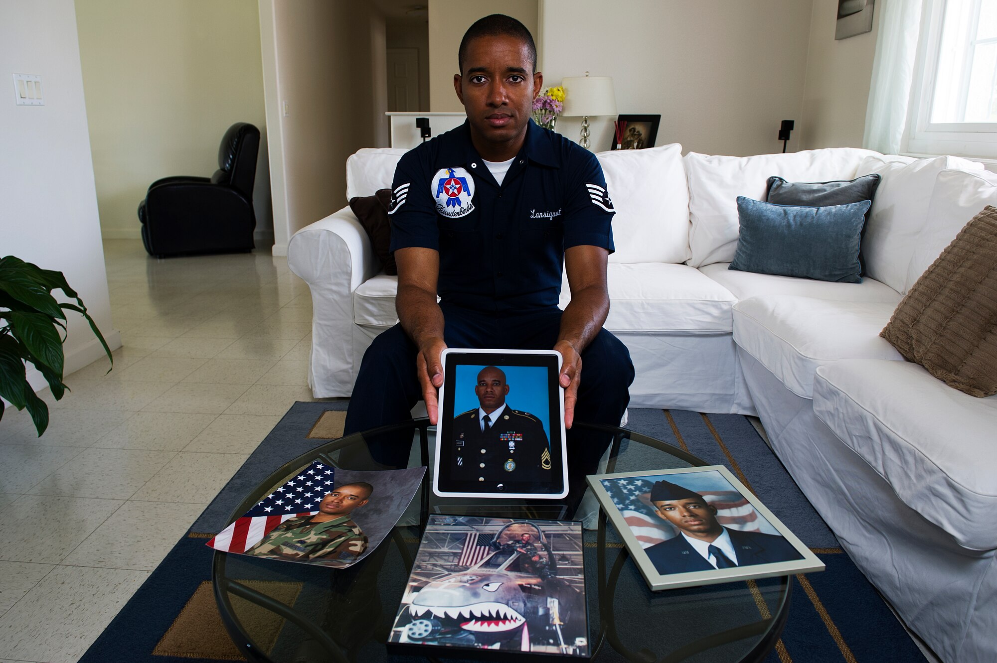 Staff Sgt. McGarry Lansiquot holds a portrait of his older brother, U.S. Army Sgt. 1st Class McGarret Lansiquot, at his home in Las Vegas, Nev., May 16, 2013. Sgt. Lansiquot and his twin brother, McGarret are both from Castries, St. Lucia, an island country located in the eastern Caribbean Sea.
(U.S. Air Force photo/Staff Sgt. Larry E. Reid Jr.)