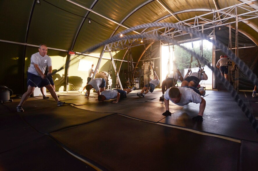 Instructors from the United States Air Force Reserve Command Expeditionary Combat Support Training Certification Center, Dobbins Air Reserve Base, Ga., participate in the TRX 3x3 Tactical Workout program conducted by John Mikula, base exercise physiologist July 17. The intensive fitness program is designed to improve strength and endurance. (U.S. Air Force photo/Don Peek)