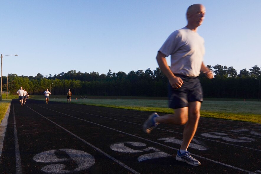 Instructors from the United States Air Force Reserve Command Expeditionary Combat Support Training Certification Center, Dobbins Air Reserve Base, Ga., participate in an early morning high intensity run at the base running track July 17. The run is just one part of an intensive tactical fitness program designed to improve strength and endurance. (U.S. Air Force photo/Don Peek)