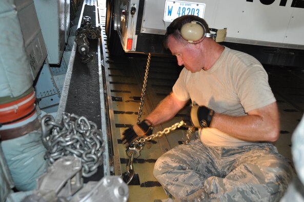 Maj. Harold Hill of the Consequence Management Team from the Texas Air National Guard secures a trailer with a chain during a training session with the 433rd Airlift Control Flight.  These Expeditionary Medical System members from the 433rd ACLF trained the Guardsmen on loading, securing and unloading their vehicles onto a C-5A Galaxy from the 433rd Airlift Wing. (U.S. Air Force Photo by Tech. Sgt. Carlos  Trevino)