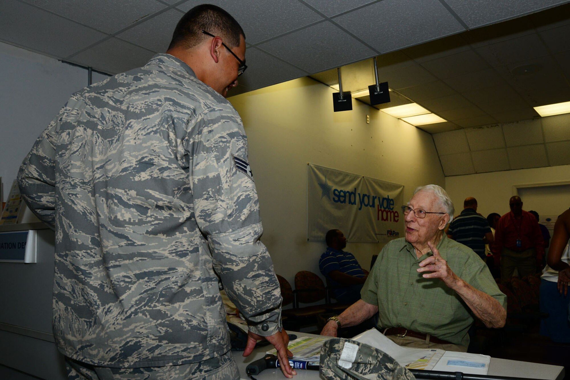 U.S. Air Force Senior Airman Scott Stanley, left, 735th Supply Chain Operations Group unit deployment manager, asks retired U.S. Army Col. Edgar Wood, 633rd Medical Group volunteer, for directions at the U.S. Air Force Hospital Langley, at Langley Air Force Base Va., July 16, 2013. Wood has been a part of the Retiree Volunteer Program for the last 14 years after serving 32 years in the Army. (U.S. Air Force photo by Staff Sgt. Ashley Hawkins/Released)