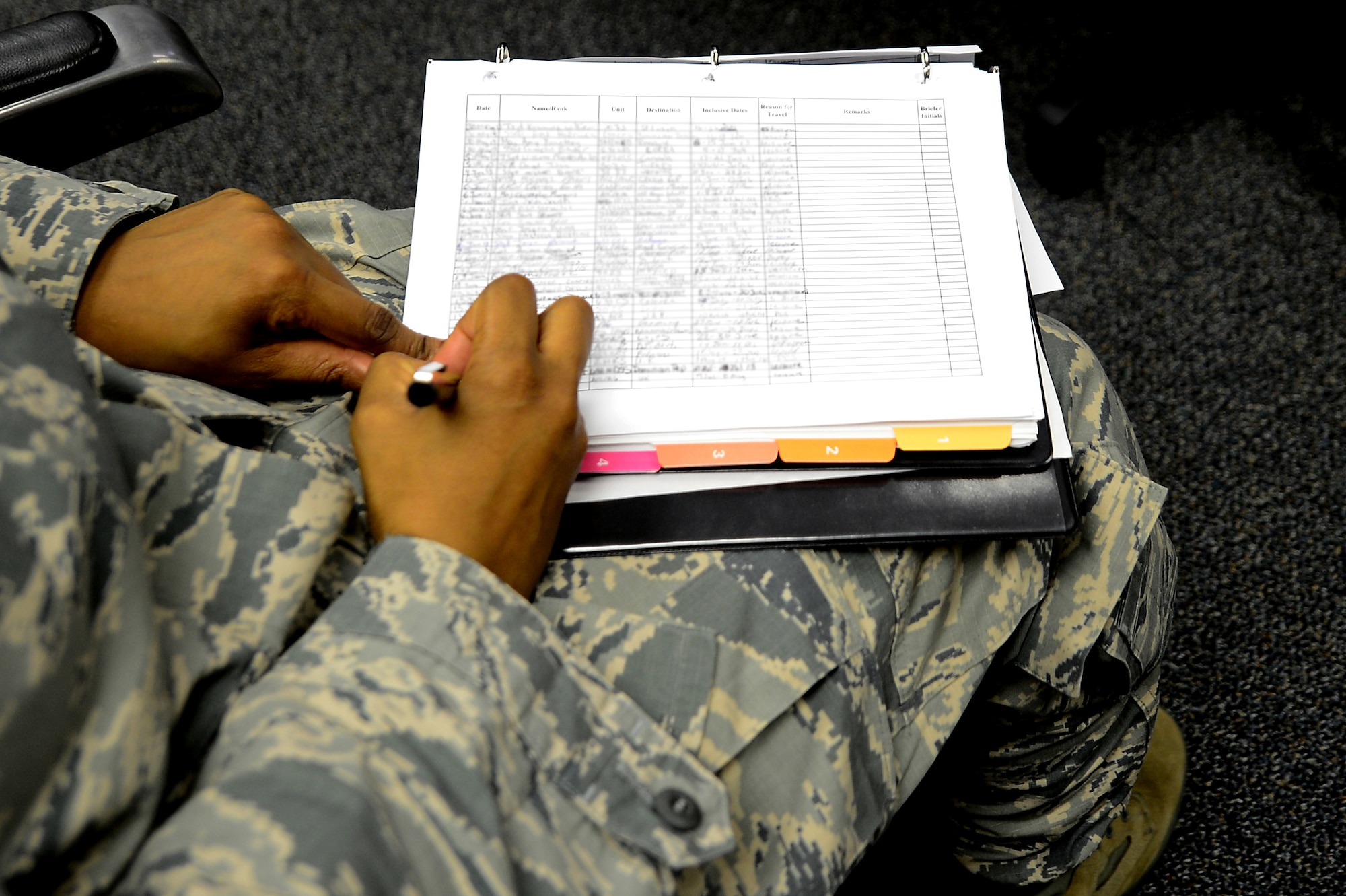 A U.S. Air Force Airman signs into the Air Force Office of Special Investigations travel briefing at Langley Air Force Base, Va., July 11, 2013. Before taking leave outside of the U.S., Service members are encouraged to contact AFOSI in advance of the mandatory training, so a specific briefing can be tailored for the location the member is traveling to.  (U.S. Air Force photo by Senior Airman Kayla Newman/Released)