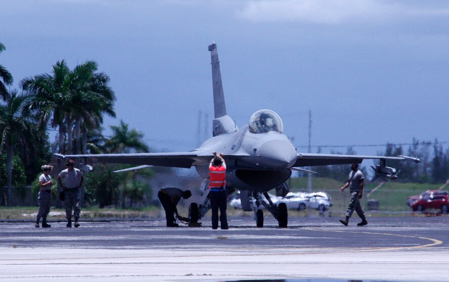 Airmen prepare an F-16 for takeoff at Homestead Air Reserve Base, Fla., July 10. The pilots of Homestead ARB currently hone their skills on two flight simulators. These simulators allow pilots to go from studying to jumping in a simulator to put what they learned immediately into practice. (U.S. Air Force photo/Senior Airman Jaimi Upthegrove)