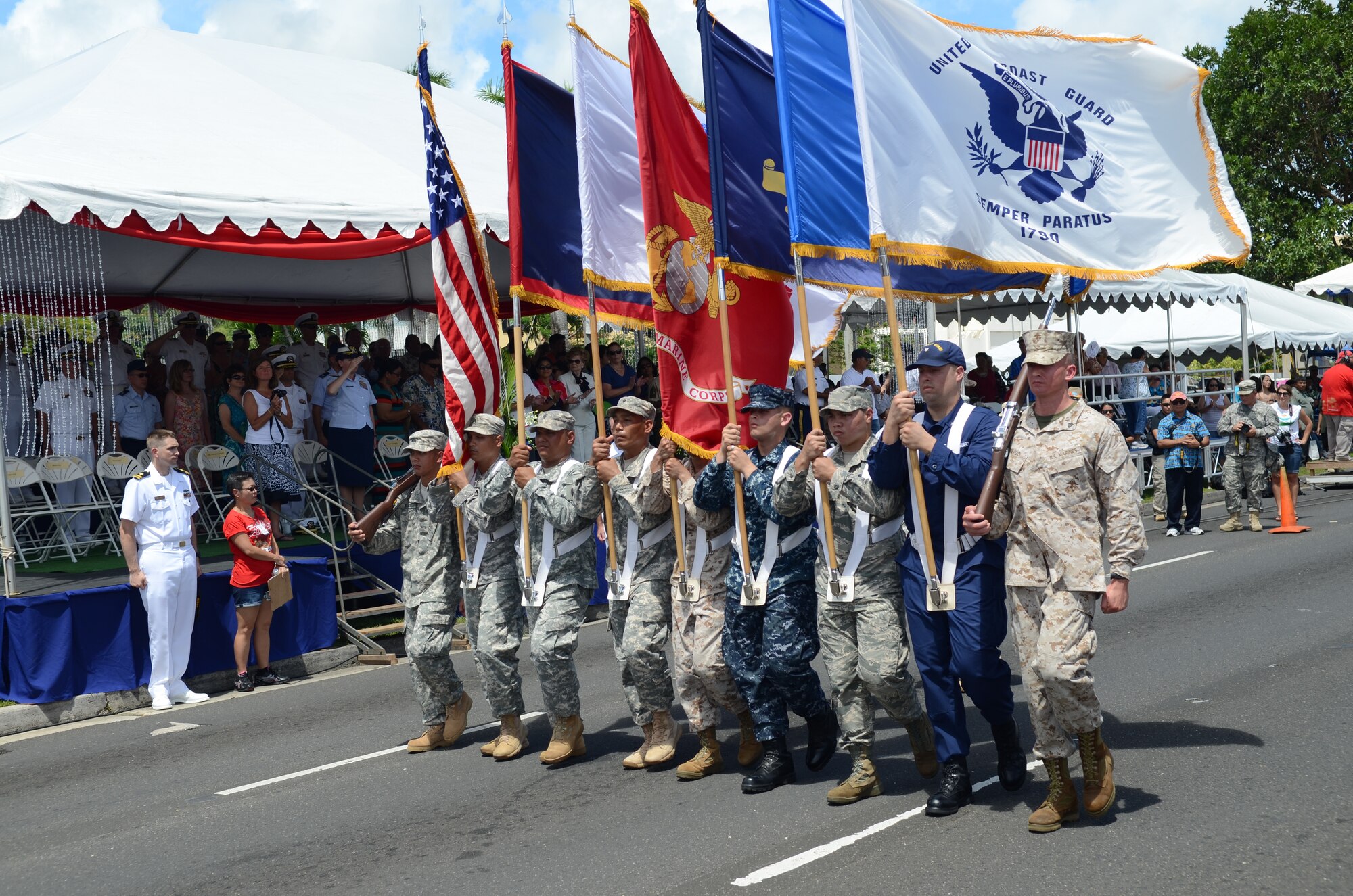 A joint color guard, comprised of service members from various guard and Reserve units stationed on the island, pass the 69th Guam Liberation Day parade grand stand in Hagåtña, Guam, July 21, 2013. Formations of active-duty service members, guardsmen and reservists, including more than 140 Airmen from the 36th Wing, led the parade down the 1.2-mile route past thousands of spectators. The parade commemorated the United States freeing the island from imperial Japan’s control during the Second Battle of Guam, which began July 21, 1944, and lasted 21 days. (U.S. Air Force photo by Staff Sgt. Brok McCarthy/Released)