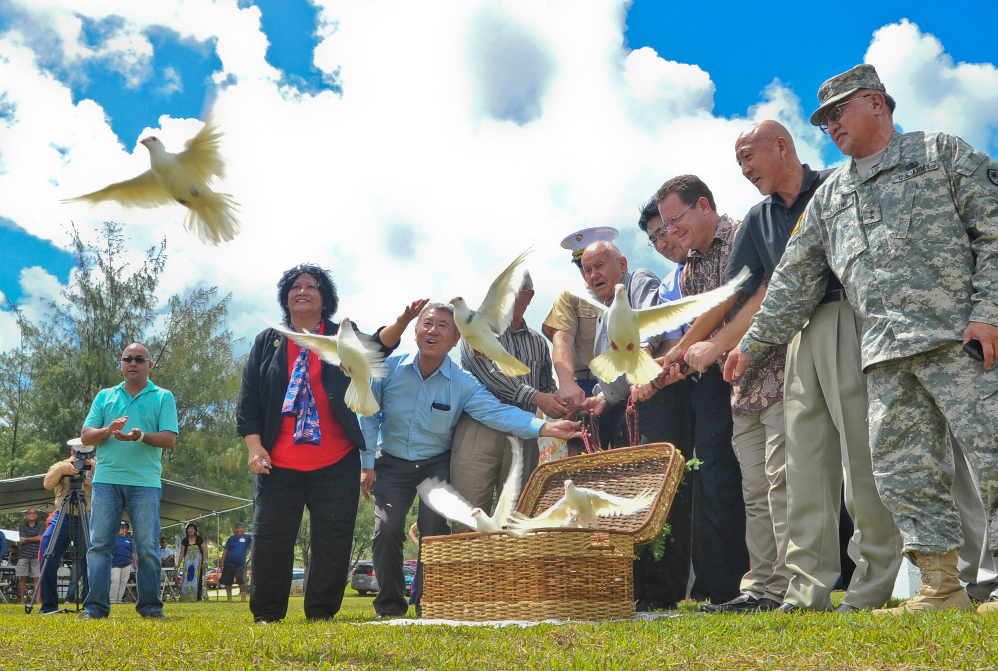ASAN, Guam -- Joint Region Marianas military leaders and Guam dignitaries release birds to signify freedom during a memorial ceremony in Asan, Guam, July 18, 2013. The memorial ceremony recognized the sacrifices made by U.S. service members and local citizens during the liberation of Guam from Japanese forces in 1944. (U.S. Air Force photo by Airman 1st Class Adarius Petty/Released)