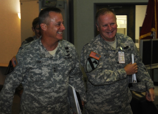 U.S. Army Engineering and Support Center commander Col. Robert Ruch (right) escorts Maj. Gen. Kendall Cox, U.S. Army Corps of Engineers Deputy Commanding General – Military and International Operations, through a series of office calls and briefings at Huntsville Center July 23. Cox is responsible for policy, programming, and technical support in the execution of over $28 billion of design, construction, and environmental programs for the Army, the Air Force, other Department of Defense and federal agencies and foreign countries.