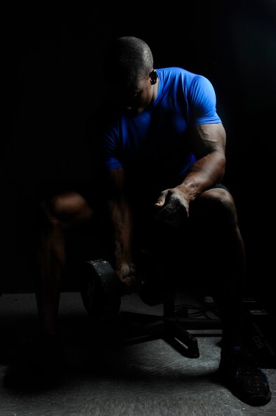 Staff Sgt. Robert Timms, 8th Aircraft Maintenance Squadron unit fitness program manager, performs a bicep curl while at Kunsan Air Base, Republic of Korea, July 19, 2013. Timms has been physically active his entire life, participating in activities including Sho-To-Kan karate and football. (U.S. Air Force photo by Senior Airman Jessica Haas/Released) 