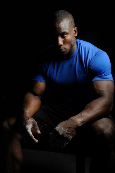 Staff Sgt. Robert Timms, 8th Aircraft Maintenance Squadron unit fitness program manager, focuses on the dumbbells he will lift while at Kunsan Air Base, Republic of Korea, July 19, 2013. Timms is a strong believer of being able to accomplish anything one sets their mind to, as he was once diagnosed with cancer and is now completely cured. (U.S. Air Force photo by Senior Airman Jessica Haas/Released)