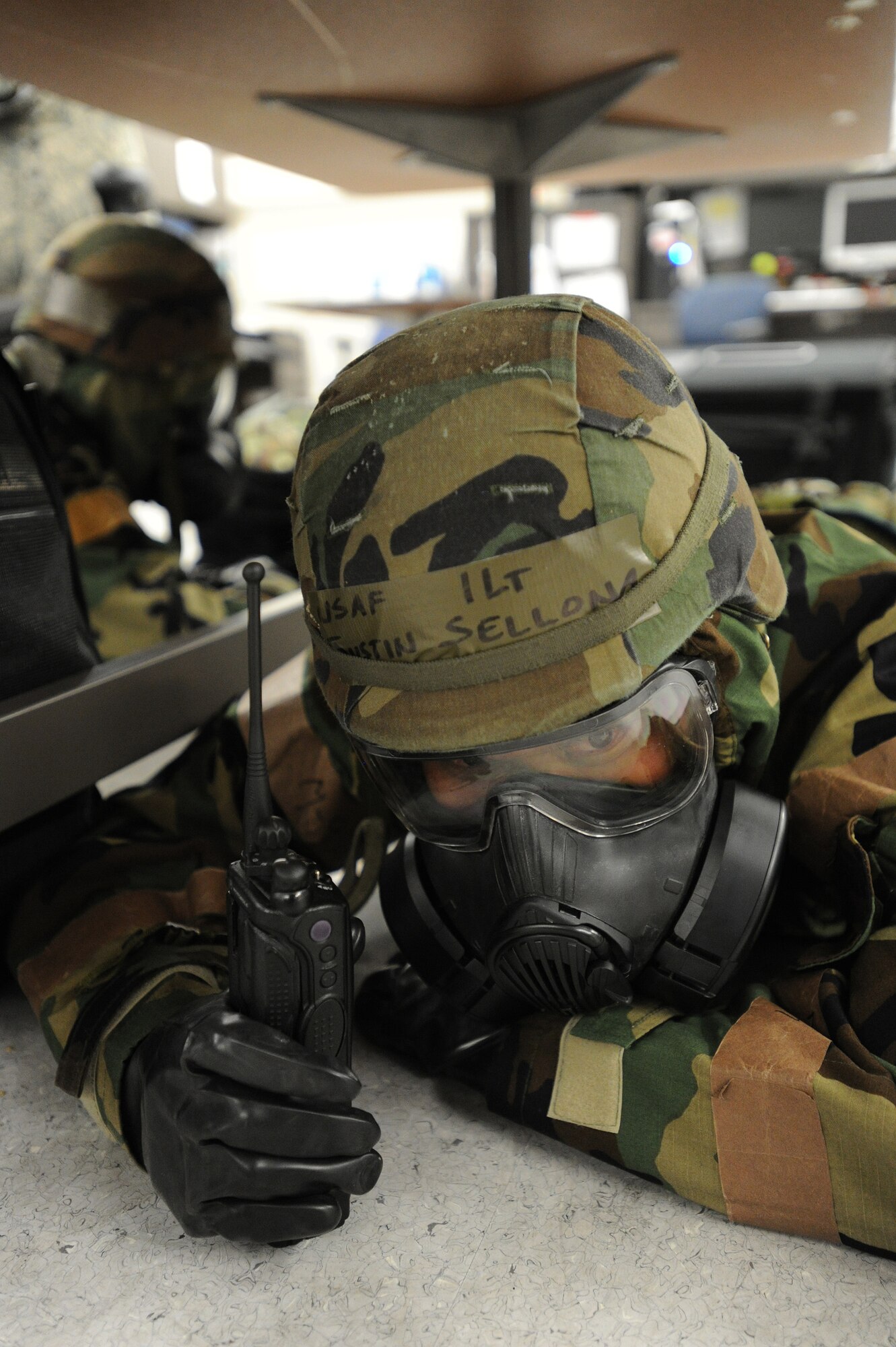 Members of the 15th Wing and the Hawaii Air National Guard 154th Wing take cover while in mission-oriented protective posture four at Hangar 13 during an Operational Readiness Exercise at Joint Base Pearl Harbor-Hickam, Hawaii, July 18, 2013. (U.S. Air Force photo/Tech. Sgt. Jerome S. Tayborn)  