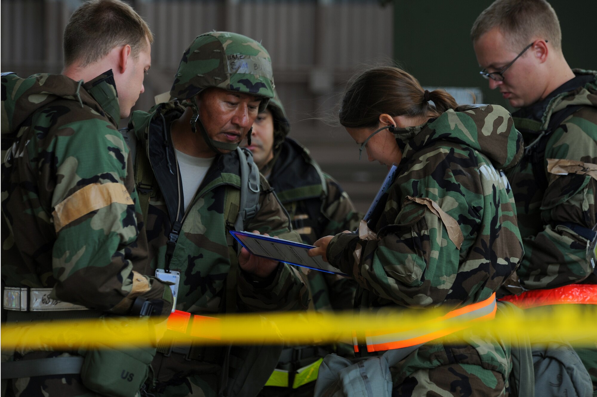 Members of the 15th Wing and the Hawaii Air National Guard 154th Wing discuss operation procedures at Hangar 13 during an Operational Readiness Exercise at Joint Base Pearl Harbor-Hickam, Hawaii, July 18, 2013. This exercise demonstrates the effective use of Total Force Integration by including both 15th Wing and 154th HIANG Airmen working side-by-side to accomplish a mission. (U.S. Air Force photo/Tech. Sgt. Jerome S. Tayborn)  