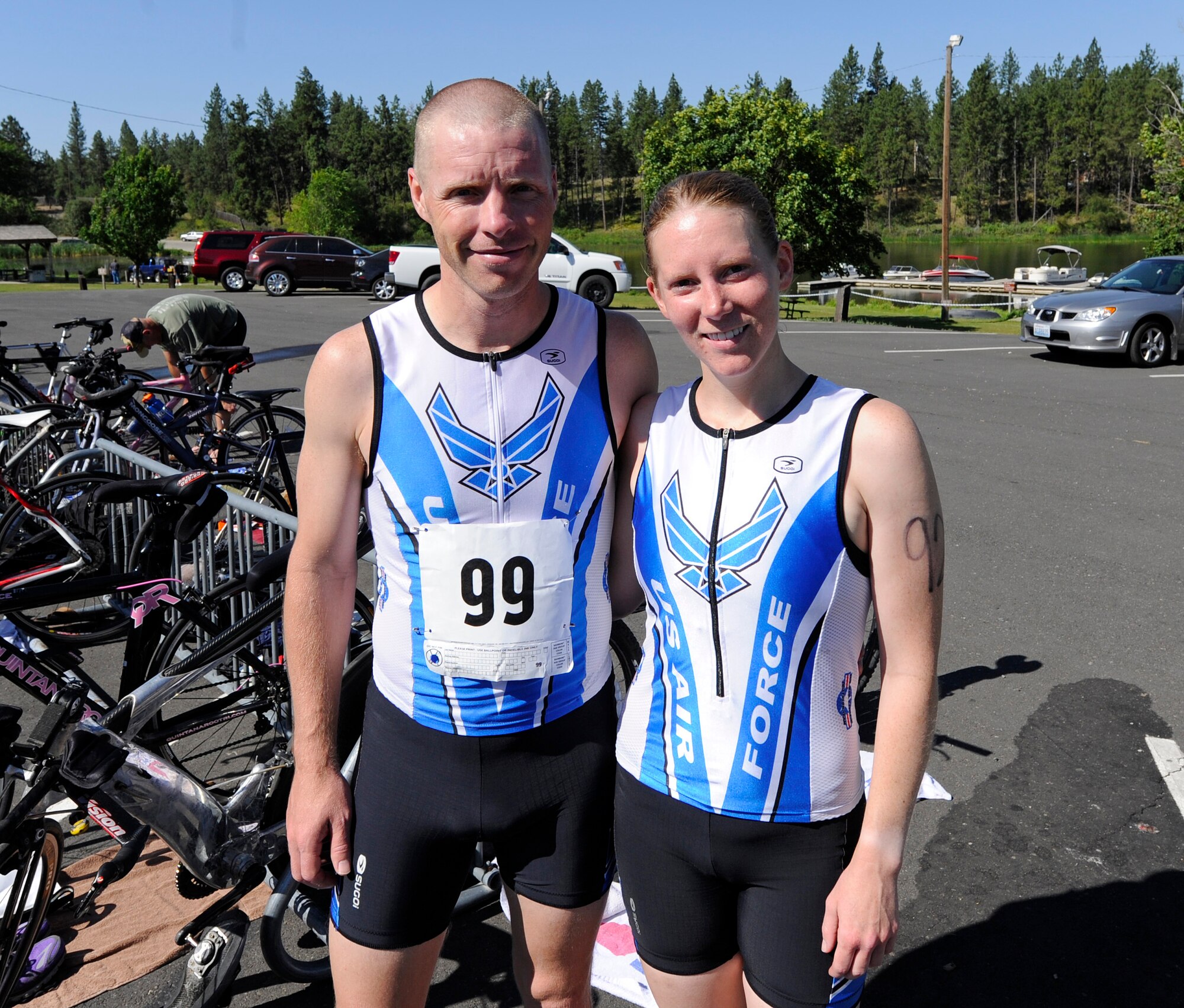 Tech. Sgt. Michael Bergquist, Air National Guard, and his wife, Staff Sgt. Amanda Bergquist, 141st Medical Group, pose for a photo after the Clear Lake triathlon near Medical Lake, Wash., July 20, 2013. Michael and Amanda both finished first in the male and female category. (U.S. Air Force photo by Airman 1st Class Ryan Zeski/Released)