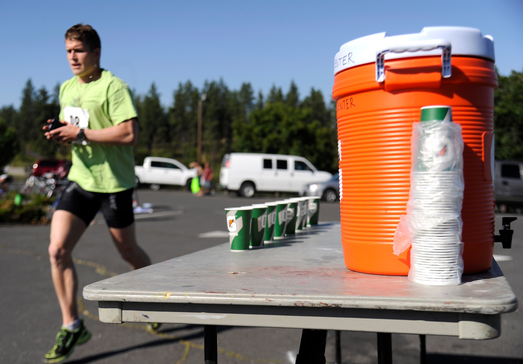 Airman 1st Class Drew Hall, 92nd Aerospace Medicine Squadron, begins the 5k run for the final leg of the triathlon at Clear Lake Resort near Medical Lake, Wash., July 20, 2013. Hall finished 2nd place in the males elite category. (U.S. Air Force photo by Airman 1st Class Ryan Zeski/Released)