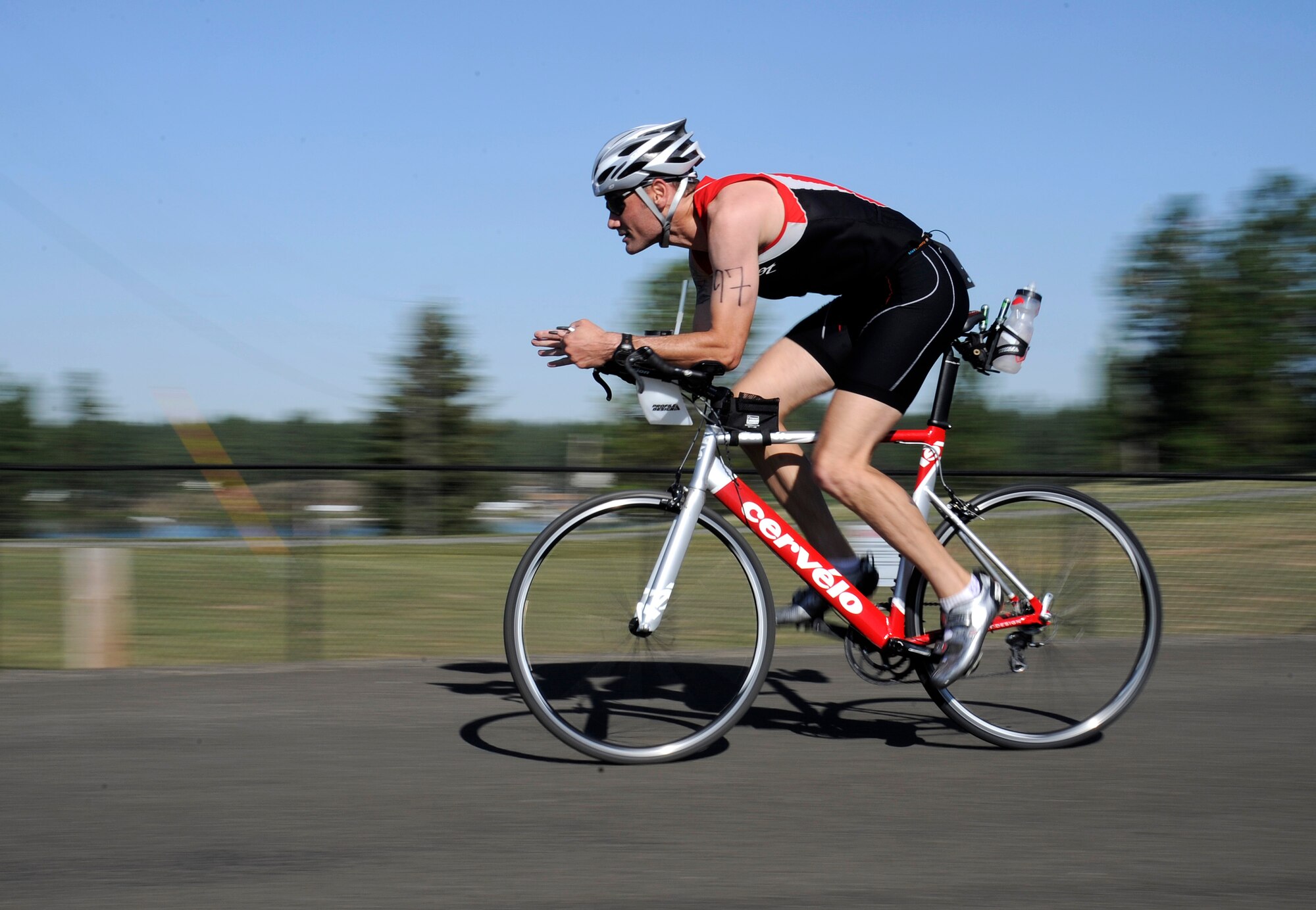 A participant in the Clear Lake triathlon completes one of two laps for the biking portion of the race near Medical Lake, Wash., July 20, 2013. Racers are required to complete 15 miles before starting the final phase of the race. (U.S. Air Force photo Airman 1st Class Ryan Zeski/Released) 