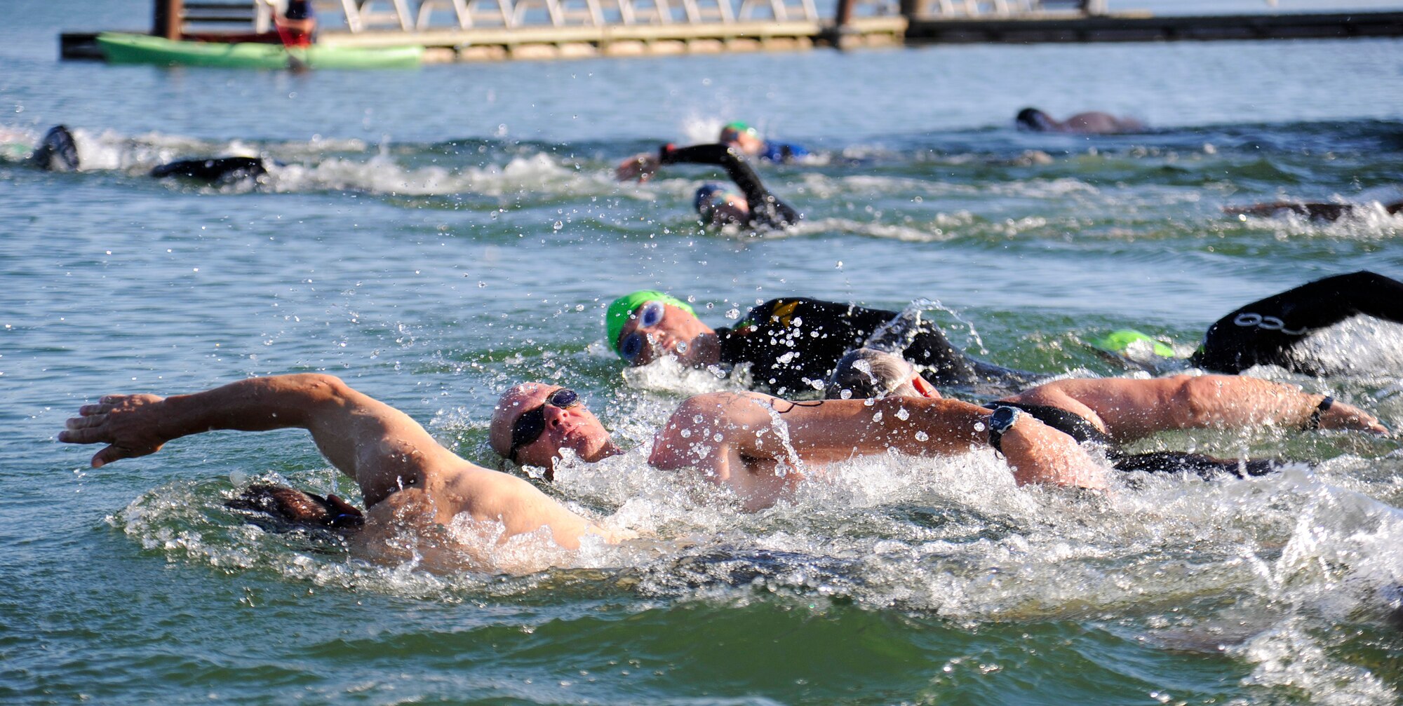 Members of Team Fairchild start off the triathlon in the swimming portion at Clear Lake Resort near Medical Lake, Wash., July 20, 2013. The swimmers must complete a total of 600 yards before moving on to the biking portion. (U.S. Air Force photo by Airman 1st Class Ryan Zeski/Released)