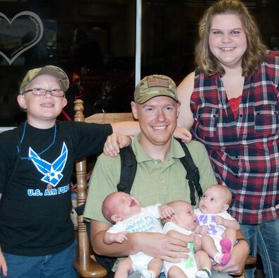 Harley and Amber Wicks pose for a picture with their newborn triplets and Harley’s older son Parker McKinney following Harley’s July 15, 2013, return from his deployment.  The triplets were born about four months into Harley’s six-and-a-half-month deployment.  (Courtesy photo)