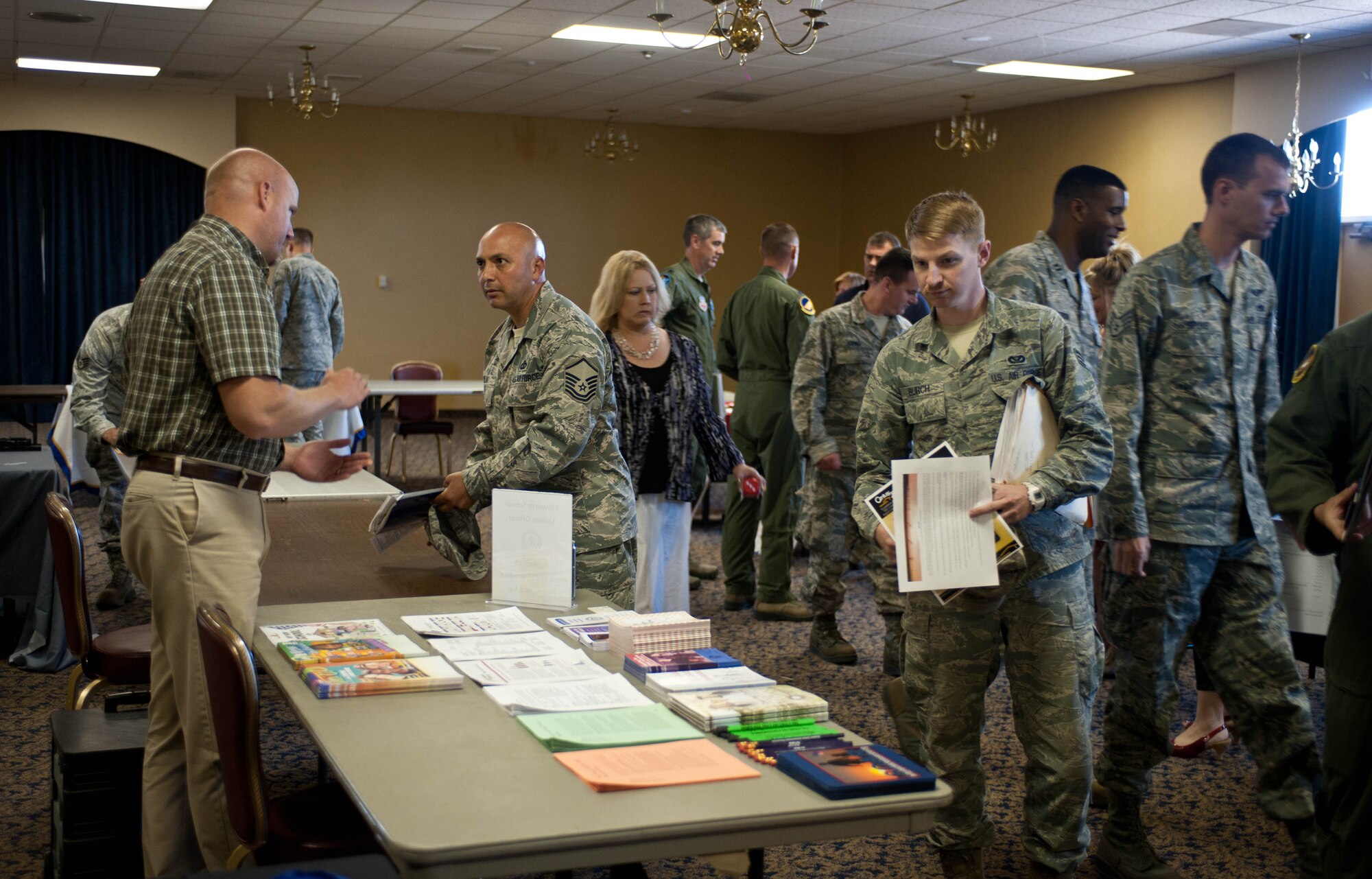 Airmen check out various information booths during Happy Landings in the Dakota’s Club at Ellsworth Air Force Base, S.D., July 16, 2013. Happy Landings, a monthly fair for both current Ellsworth members and newcomers, is designed to keep Airmen updated on all the services and resources Ellsworth and community have to offer. (U.S. Air Force photo by Airman 1st Class Zachary Hada/Released)